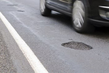 Pothole On The Road Next To A Driving Car Royalty Free Image 1642169984